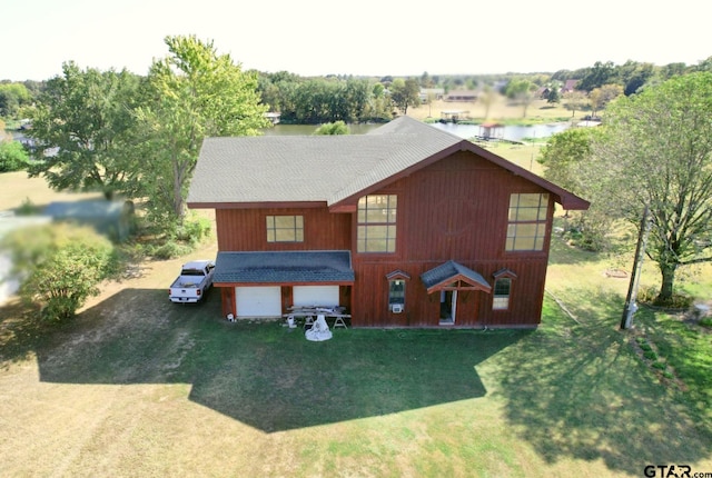 view of front of house with a garage and a front yard