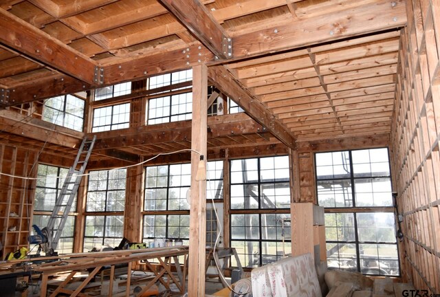 misc room featuring wooden ceiling, a wealth of natural light, and vaulted ceiling with beams