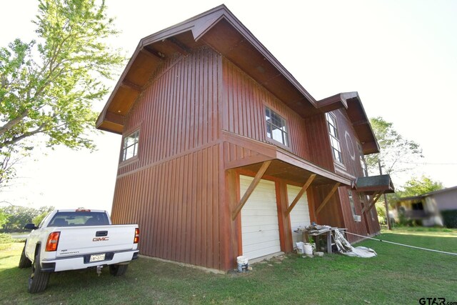 view of property exterior featuring a lawn