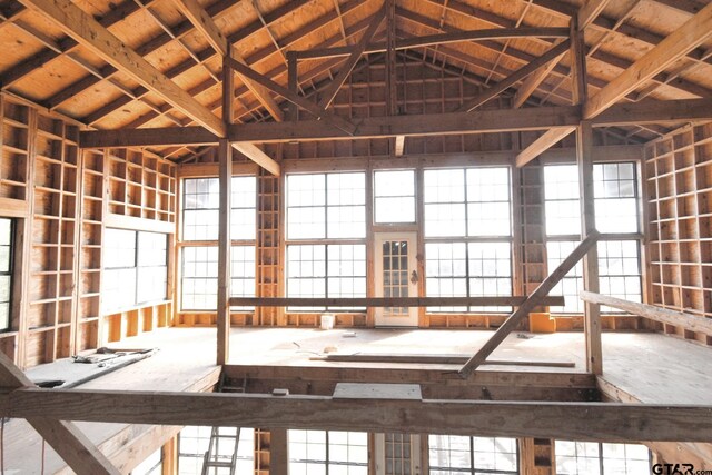 misc room with vaulted ceiling with beams