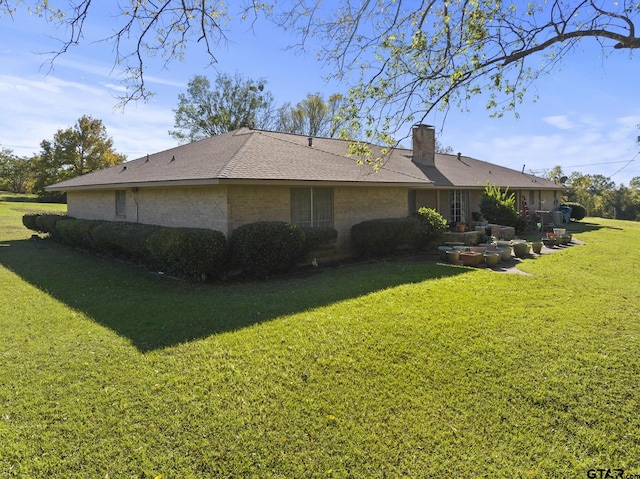 view of property exterior with a lawn