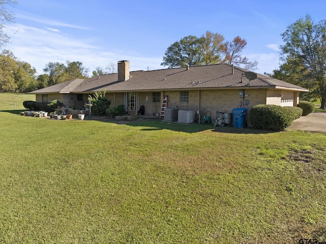 back of property with cooling unit and a lawn