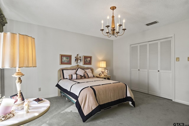 carpeted bedroom featuring a closet, a textured ceiling, and a notable chandelier