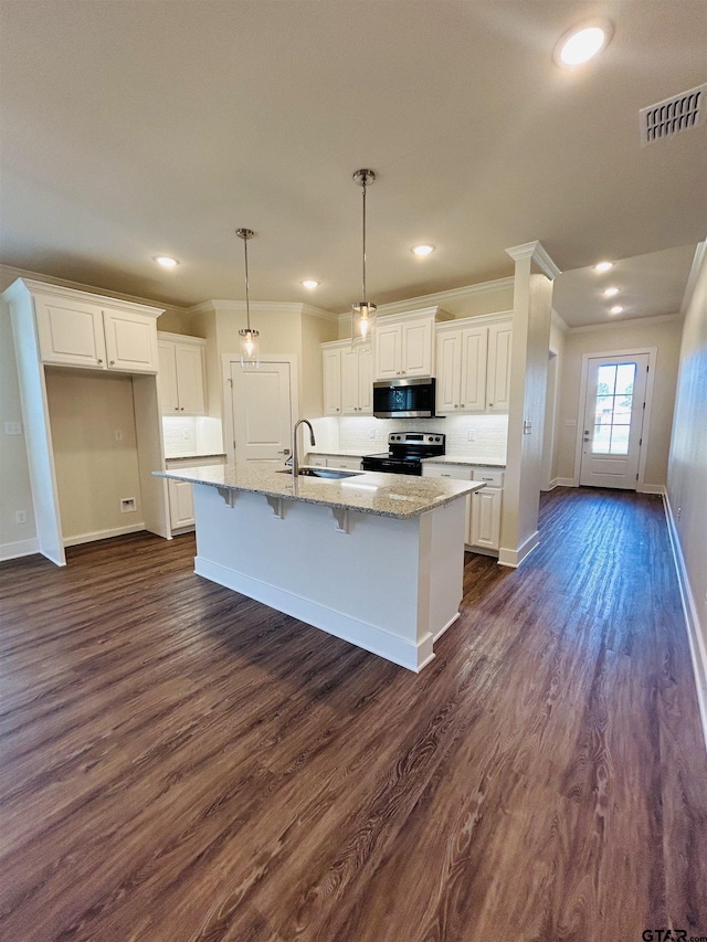 15033 High Country Acres Ln, Tyler, TX 75706 - kitchen featuring appliances with stainless steel finishes, ornamental molding, dark wood finished floors, white cabinets, and light stone countertops