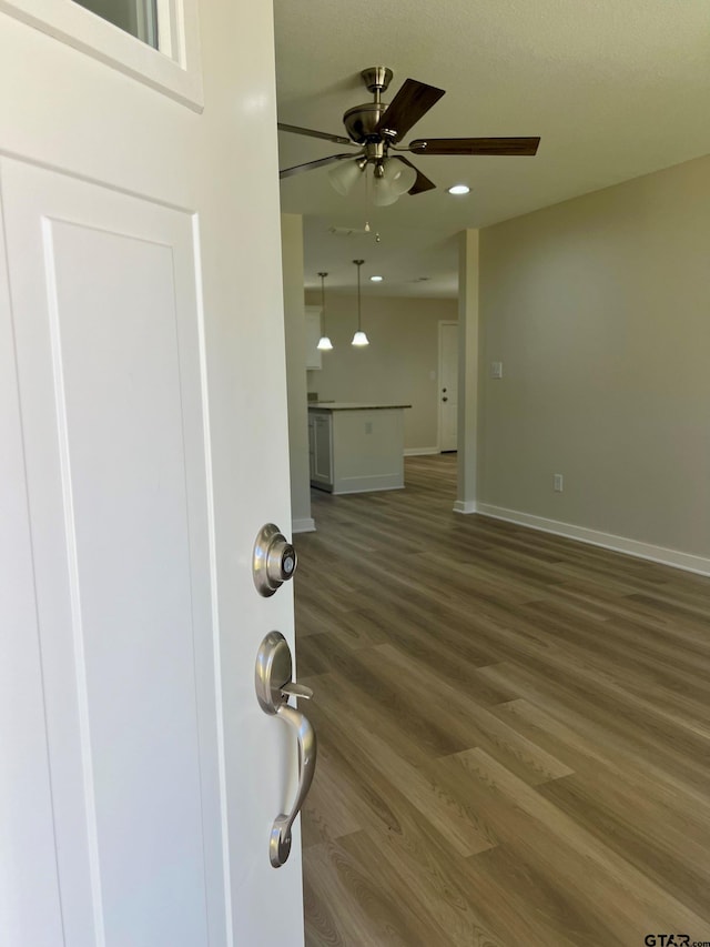 interior space with hardwood / wood-style flooring and ceiling fan