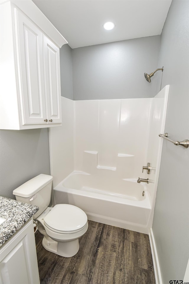 full bathroom with hardwood / wood-style floors, vanity, toilet, and shower / bath combination