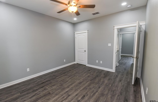 unfurnished bedroom with dark hardwood / wood-style floors and ceiling fan