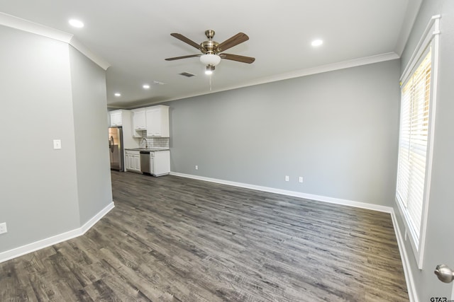 unfurnished living room featuring dark hardwood / wood-style floors, ceiling fan, and crown molding