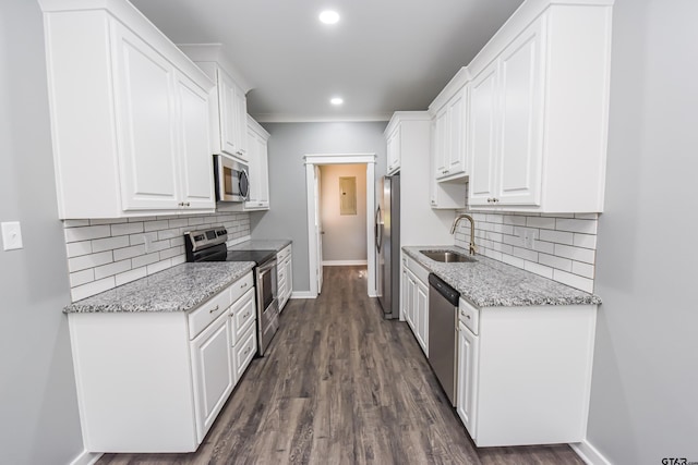 kitchen with white cabinetry, sink, stainless steel appliances, and light stone counters