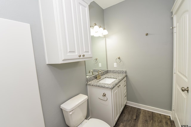 bathroom featuring hardwood / wood-style floors, vanity, and toilet