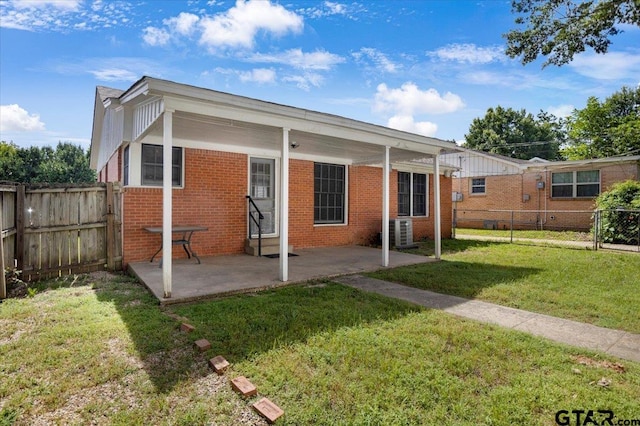 1931 S Wiley, Tyler, TX 75701 - back of property with brick siding, a fenced backyard, and a patio area