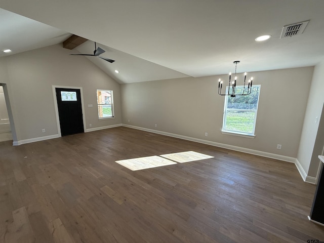 interior space featuring ceiling fan with notable chandelier, vaulted ceiling with beams, dark hardwood / wood-style flooring, and a wealth of natural light