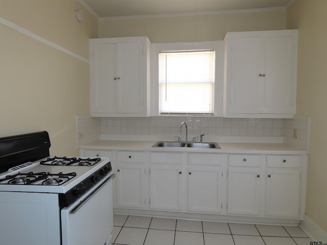 kitchen with tasteful backsplash, crown molding, sink, white cabinetry, and white gas stove