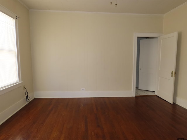 spare room with crown molding, dark hardwood / wood-style flooring, and plenty of natural light