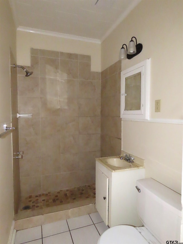 bathroom featuring a tile shower, tile patterned flooring, vanity, and toilet