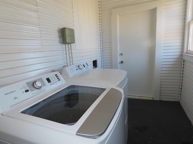 washroom featuring washer and dryer and wooden walls