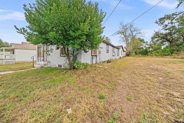 view of side of property with a yard