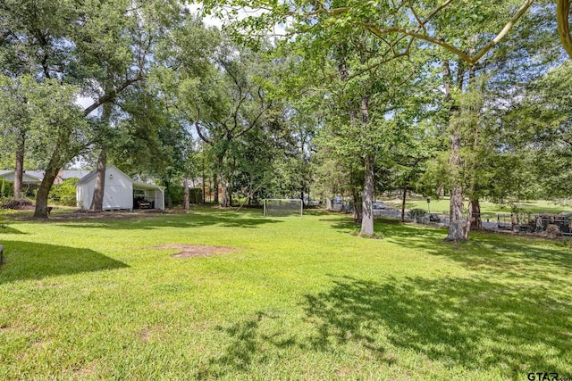 312 Savannah Dr, Tyler, TX 75703 - view of yard featuring a detached carport and an outbuilding