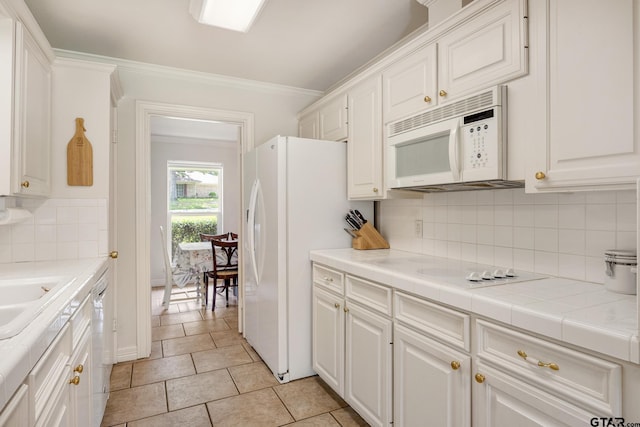 312 Savannah Dr, Tyler, TX 75703 - kitchen featuring white appliances, white cabinets, decorative backsplash, ornamental molding, and tile countertops