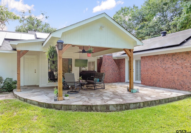 312 Savannah Dr, Tyler, TX 75703 - rear view of property featuring a ceiling fan, a patio, a yard, and brick siding