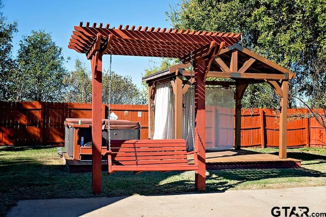 view of play area with a yard, a pergola, and a hot tub