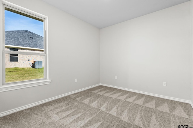 carpeted spare room featuring a wealth of natural light