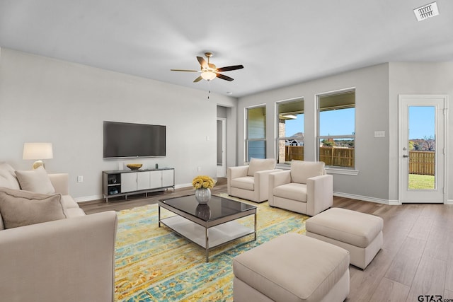 living room featuring hardwood / wood-style flooring and ceiling fan