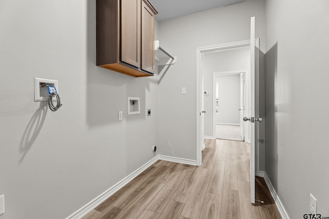 clothes washing area with electric dryer hookup, cabinets, hookup for a washing machine, and light hardwood / wood-style flooring