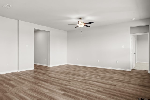 spare room featuring hardwood / wood-style floors and ceiling fan