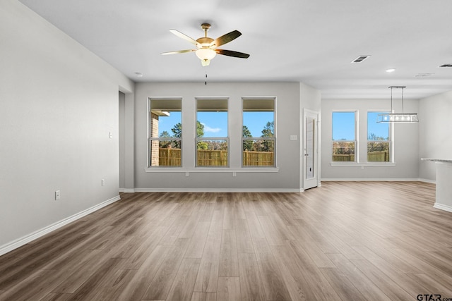 spare room with wood-type flooring and ceiling fan