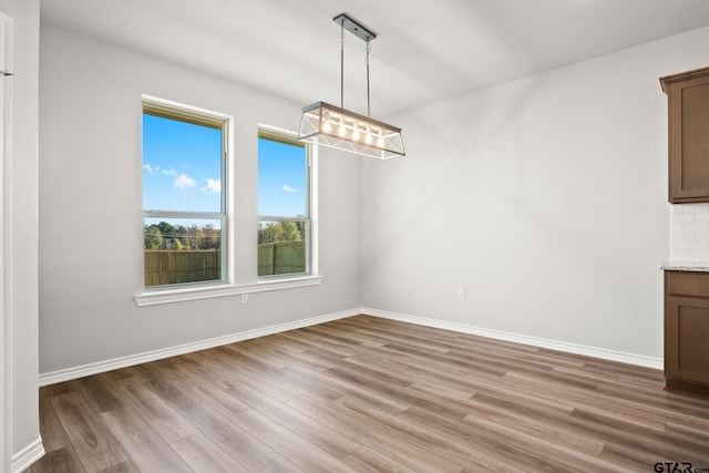 unfurnished dining area with wood-type flooring