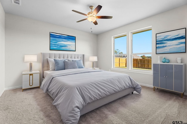 bedroom featuring ceiling fan and light carpet