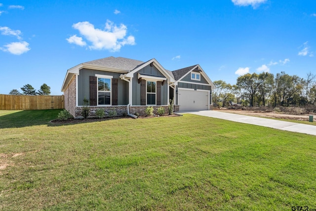 craftsman inspired home featuring a garage and a front lawn