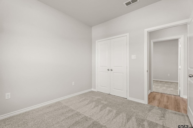 unfurnished bedroom featuring carpet flooring and a closet