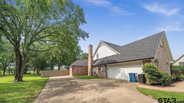 2107 Baylor Dr, Jacksonville, TX 75766 - view of property exterior featuring driveway, brick siding, a garage, a shingled roof, and a chimney