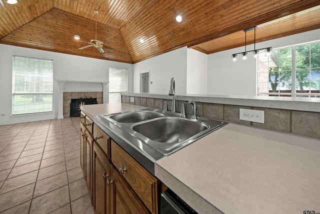 2107 Baylor Dr, Jacksonville, TX 75766 - kitchen with wood ceiling, a sink, a ceiling fan, a fireplace, and open floor plan