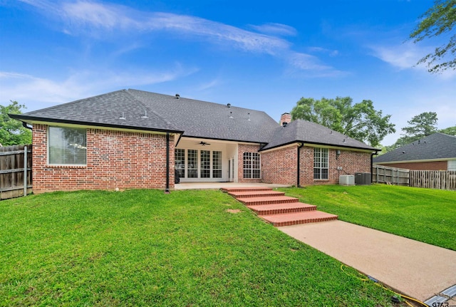 2107 Baylor Dr, Jacksonville, TX 75766 - rear view of property featuring a ceiling fan, a patio, brick siding, and roof with shingles