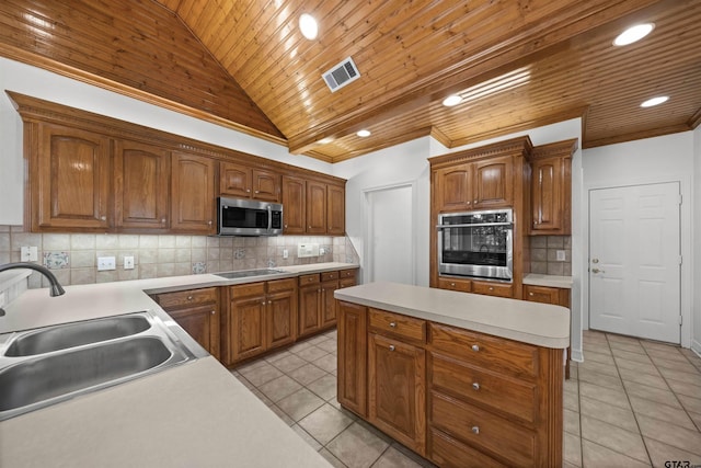2107 Baylor Dr, Jacksonville, TX 75766 - kitchen with stainless steel appliances, a sink, wood ceiling, vaulted ceiling, and light tile patterned floors