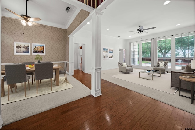 2107 Baylor Dr, Jacksonville, TX 75766 - dining room with decorative columns, a ceiling fan, wallpapered walls, dark wood finished floors, and baseboards