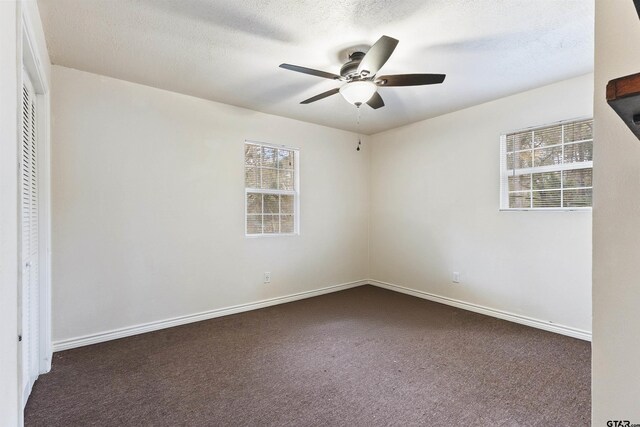 371 Shadybrook Dr, Bullard, TX 75757 - unfurnished bedroom featuring dark colored carpet, a closet, a ceiling fan, and baseboards
