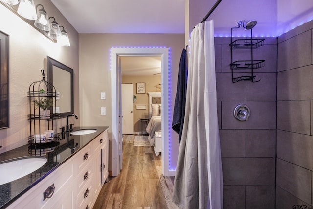 765 Rs County Road 3410, Emory, TX 75440 - ensuite bathroom featuring wood finished floors, double vanity, and a shower with shower curtain