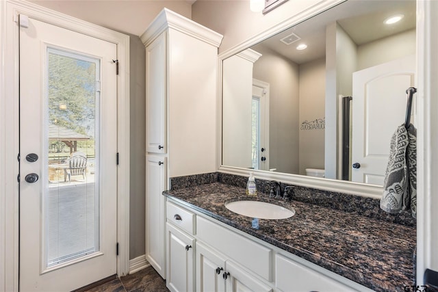 bathroom with vanity and toilet