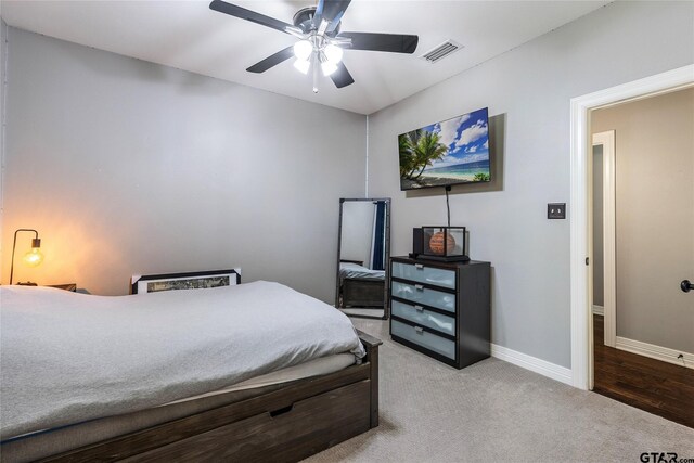 bedroom with hardwood / wood-style floors and ceiling fan