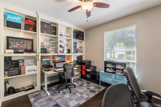 home office with ceiling fan and dark hardwood / wood-style flooring