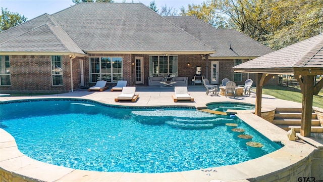 view of pool with a patio and an in ground hot tub