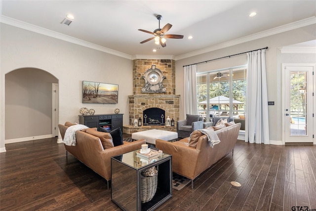 living room featuring ornamental molding, a fireplace, plenty of natural light, and dark wood-type flooring