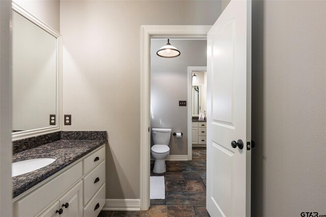 bathroom featuring toilet and vanity