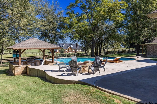 view of swimming pool with a patio, a yard, a gazebo, and a hot tub