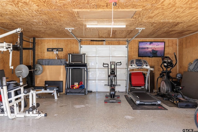 exercise area featuring wood walls