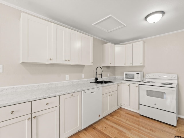 kitchen with white appliances, crown molding, sink, light hardwood / wood-style floors, and white cabinetry